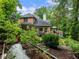 Lush backyard featuring a vegetable garden, mature trees, and an inviting outdoor living space at 350 Fountain Oaks Ln, Atlanta, GA 30342