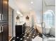 Modern bathroom features a soaking tub, glass shower, and black and white tiled floors at 350 Fountain Oaks Ln, Atlanta, GA 30342