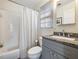 Bright bathroom with a white shower curtain, grey vanity, and modern fixtures at 350 Fountain Oaks Ln, Atlanta, GA 30342