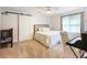 Bright bedroom featuring a sliding barn door, ceiling fan, and neutral carpet and paint at 350 Fountain Oaks Ln, Atlanta, GA 30342