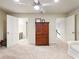 Spacious bedroom with a wooden dresser between two doorways and neutral carpeting at 350 Fountain Oaks Ln, Atlanta, GA 30342