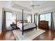Comfortable bedroom with hardwood floors, four-poster bed, neutral walls, and natural light at 350 Fountain Oaks Ln, Atlanta, GA 30342