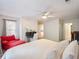 Comfortable bedroom with a red chaise lounge, ceiling fan, and a shiplap accent wall at 350 Fountain Oaks Ln, Atlanta, GA 30342