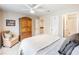 Cozy bedroom with a ceiling fan, decorative armoire, and adjoining bathroom at 350 Fountain Oaks Ln, Atlanta, GA 30342