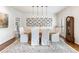 Formal dining room with a long wooden table, upholstered chairs, modern pendant lighting, and hardwood floors at 350 Fountain Oaks Ln, Atlanta, GA 30342