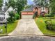 Traditional two-story brick home with a well-manicured lawn and driveway at 350 Fountain Oaks Ln, Atlanta, GA 30342