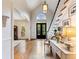 Hardwood floors, staircase, and a view through the doorway with natural light from the arched window above entry door at 350 Fountain Oaks Ln, Atlanta, GA 30342