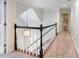 Upstairs hallway with neutral carpet and dark wood railings that leads to the home's bedrooms at 350 Fountain Oaks Ln, Atlanta, GA 30342