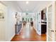 Bright hallway with hardwood floors leading to a sunlit living area and a view of the kitchen at 350 Fountain Oaks Ln, Atlanta, GA 30342