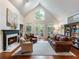 Bright living room with vaulted ceilings, a fireplace, hardwood floors, and a view to the outside deck at 350 Fountain Oaks Ln, Atlanta, GA 30342