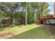 Backyard with a covered patio, trees, and a grassy area at 621 Windgrove Se Dr, Marietta, GA 30067
