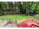 Backyard and mature trees from a high point of view with deck and red stairs at 621 Windgrove Se Dr, Marietta, GA 30067