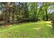 Expansive backyard featuring lush lawn and mature trees offering ample privacy and shade at 621 Windgrove Se Dr, Marietta, GA 30067