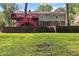 A raised rear deck with stairs overlooks the backyard with a terraced retaining wall at 621 Windgrove Se Dr, Marietta, GA 30067