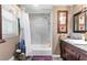 A full bathroom boasts a shower-tub combination and decoratively framed mirror at 621 Windgrove Se Dr, Marietta, GA 30067