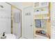 A vibrant bathroom offers a glass-enclosed shower, decoratively striped walls, and organized shelving at 621 Windgrove Se Dr, Marietta, GA 30067