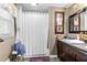 A full bathroom boasts a shower-tub combination and decoratively framed mirror at 621 Windgrove Se Dr, Marietta, GA 30067
