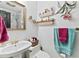 Charming bathroom showcasing pedestal sink and decorative shelves for added storage at 621 Windgrove Se Dr, Marietta, GA 30067
