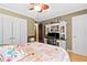 Cozy bedroom featuring a ceiling fan and built-in desk with ample storage at 621 Windgrove Se Dr, Marietta, GA 30067