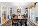 Spacious dining room with large table, built-in shelves, and adjacent to kitchen at 621 Windgrove Se Dr, Marietta, GA 30067