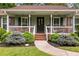 Charming home with well-manicured landscaping, walkway, and covered front porch at 621 Windgrove Se Dr, Marietta, GA 30067