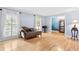 Elegant living room with hardwood floors, decorative chaise lounge, and ample natural light at 621 Windgrove Se Dr, Marietta, GA 30067