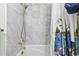 Elegant shower boasts marble tile and gold fixtures, plus a floral curtain at 621 Windgrove Se Dr, Marietta, GA 30067