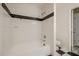Bathroom featuring a shower-tub, black and white checkered flooring, and modern fixtures at 1102 Wynnes Ridge Se Cir, Marietta, GA 30067