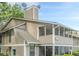 Two story home featuring neutral siding, a screened in porch, and roof chimney with satellite dishes at 1102 Wynnes Ridge Se Cir, Marietta, GA 30067