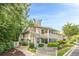 Exterior view of the condo with a green door, a screened porch, and mature landscaping at 1102 Wynnes Ridge Se Cir, Marietta, GA 30067