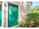 Close-up of the front door with green paint, a door knocker, and small plants at 1102 Wynnes Ridge Se Cir, Marietta, GA 30067