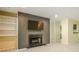 Cozy living room with built-in shelves, fireplace, TV, and light wood floors for comfortable living at 1102 Wynnes Ridge Se Cir, Marietta, GA 30067