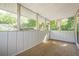 View of the screened porch with paneled walls, neutral carpet, and natural light at 1102 Wynnes Ridge Se Cir, Marietta, GA 30067