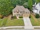 Aerial view of a home with a well-manicured lawn, two-car garage, and a charming entrance at 3595 Millwater Xing, Dacula, GA 30019