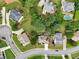 An aerial view shows the home in a well-kept neighborhood with mature trees at 3595 Millwater Xing, Dacula, GA 30019