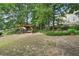 Spacious backyard featuring a wooden swing set and ample room for outdoor activities at 3595 Millwater Xing, Dacula, GA 30019