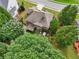 An aerial perspective highlights the backyard's trees, landscaping, and outdoor living at 3595 Millwater Xing, Dacula, GA 30019
