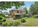 Beautifully landscaped backyard with patio, swing, screened porch, and mature trees at 3595 Millwater Xing, Dacula, GA 30019