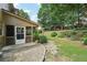 Charming backyard with stone patio, landscaped garden, and inviting screened porch at 3595 Millwater Xing, Dacula, GA 30019