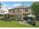 Expansive backyard features a screened porch, patio, lush landscaping, and a charming swing at 3595 Millwater Xing, Dacula, GA 30019