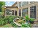 Back of house shows screened porch and natural outdoor pond, showcasing beautiful landscaping at 3595 Millwater Xing, Dacula, GA 30019
