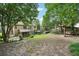 Large backyard with lush landscaping, patio, wooden swing set, and privacy fencing at 3595 Millwater Xing, Dacula, GA 30019