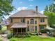 View of the home and backyard which features a covered porch, landscaping and a playset at 3595 Millwater Xing, Dacula, GA 30019