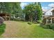 Well-maintained backyard with mature trees, green lawn, and a charming wooden swing set at 3595 Millwater Xing, Dacula, GA 30019