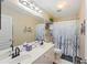 Bright bathroom with dual sinks, modern fixtures, and decorative wall accents at 3595 Millwater Xing, Dacula, GA 30019