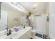 Bright bathroom with double vanity, large mirror, and shower-tub combination at 3595 Millwater Xing, Dacula, GA 30019