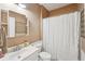 Cozy bathroom with a shower and tub combination, toilet, vanity, mirror, and neutral color scheme at 3595 Millwater Xing, Dacula, GA 30019