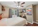 Comfortable bedroom with ceiling fan, desk, and bright natural lighting at 3595 Millwater Xing, Dacula, GA 30019