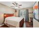 Cozy bedroom featuring unique wood-frame bed, ceiling fan, and natural light at 3595 Millwater Xing, Dacula, GA 30019