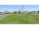 View of the clubhouse from across the golf course with manicured lawn and parking lot at 3595 Millwater Xing, Dacula, GA 30019